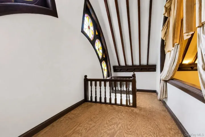 Curved landing with round stained-glass windows