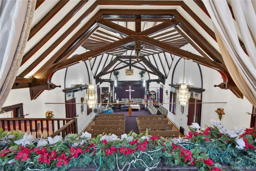Sanctuary seen from the balcony, with timber trusses and chandeliers